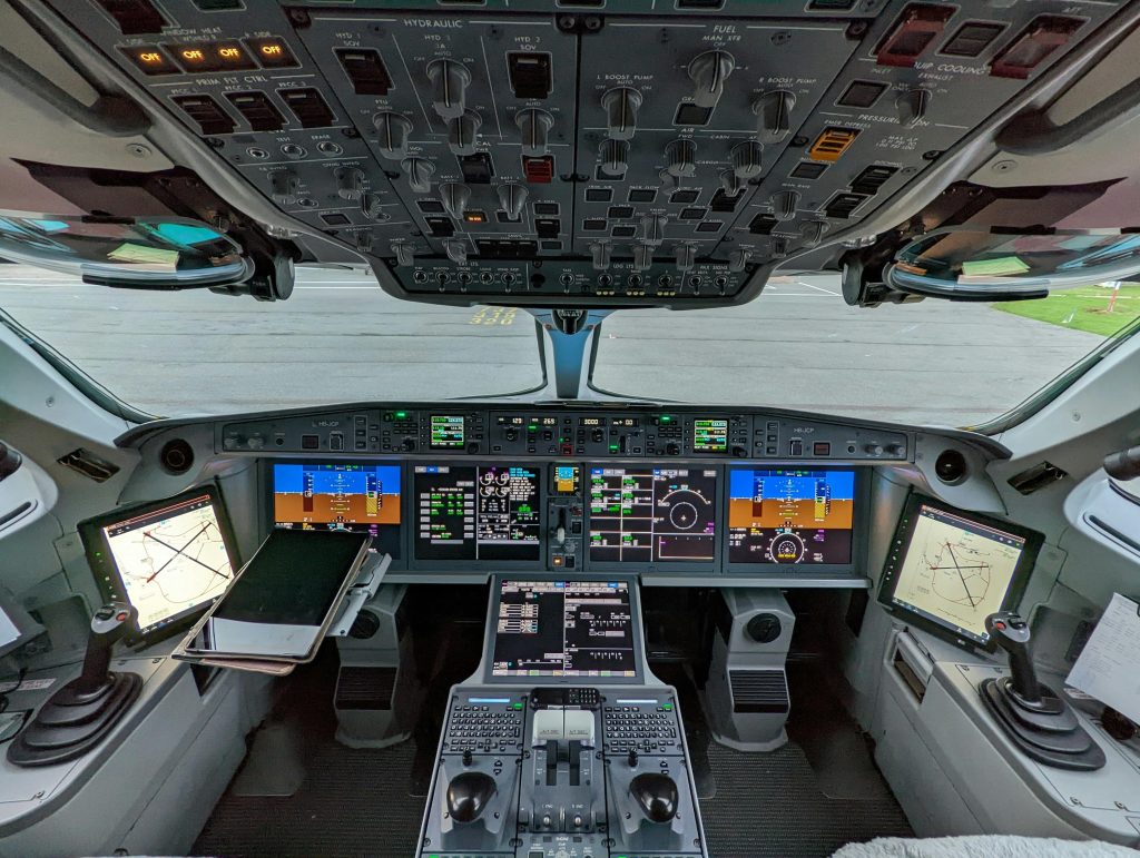 Detailed view of a modern aircraft cockpit showcasing advanced technology and instruments.